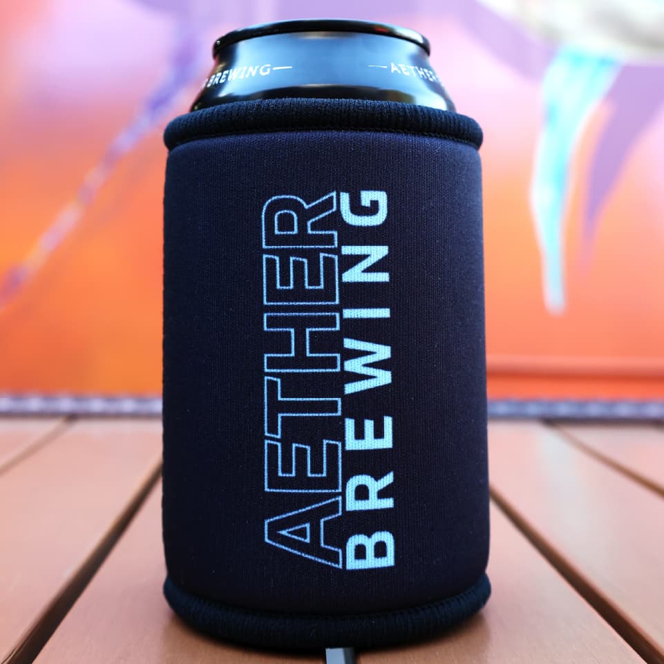 Aether Brewing stubby cooler – blue on black design, back view