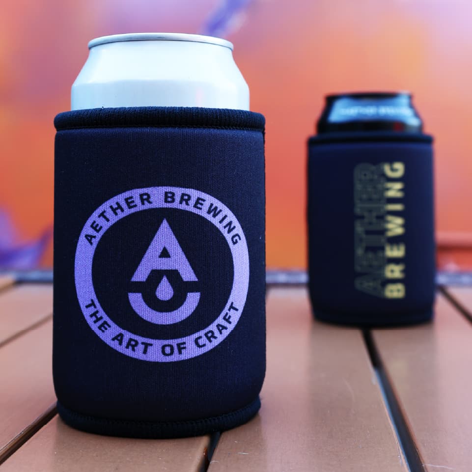 Aether Brewing stubby cooler – purple on black design, front and back shown together