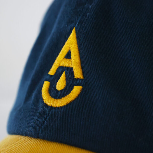 Aether Brewing Navy & Gold Cap Logo